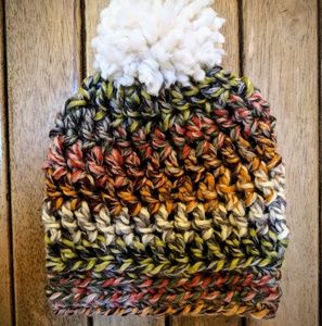 Hat in dark rainbow tones with fluffy cream pom!